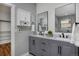 Modern bathroom features double vanity with sleek gray cabinets, marble countertop and black hardware at 1735 Crestone Dr, Longmont, CO 80504