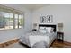 Cozy bedroom with a large window, comfortable bed, and two decorative side tables at 1735 Crestone Dr, Longmont, CO 80504