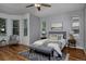 Bright bedroom features a bay window, hardwood floors, and calming gray walls at 1735 Crestone Dr, Longmont, CO 80504