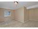 This finished bedroom features carpet, a small window, and plenty of space to move around at 1735 Crestone Dr, Longmont, CO 80504