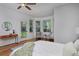 Primary bedroom with a private sitting area near the exterior door and windows at 1735 Crestone Dr, Longmont, CO 80504