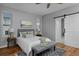 Bedroom offers natural light, gray walls, a barn door, and hardwood floors at 1735 Crestone Dr, Longmont, CO 80504