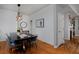 Open dining area with a black table and seating adjacent to a cozy fireplace at 1735 Crestone Dr, Longmont, CO 80504
