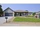 Charming single-story home with a manicured lawn and a two-car garage at 1735 Crestone Dr, Longmont, CO 80504