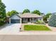 Inviting single-story home with a lush front yard and gray accents at 1735 Crestone Dr, Longmont, CO 80504