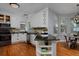 Bright kitchen with white cabinets, black countertops, and hardwood floors, ideal for cooking at 1735 Crestone Dr, Longmont, CO 80504