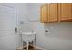 Functional laundry room features a utility sink, ample cabinet space, and convenient access to the outside at 1735 Crestone Dr, Longmont, CO 80504