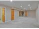 Finished basement with multiple wood doors, closet, and carpet is a perfect flex space at 1735 Crestone Dr, Longmont, CO 80504