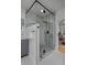 A tiled walk-in shower featuring modern fixtures and glass surround, adjacent to the vanity at 1735 Crestone Dr, Longmont, CO 80504