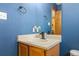 Cozy bathroom with a vessel sink, updated fixtures, and bright blue walls at 6202 Ralston St, Frederick, CO 80530