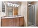 Bathroom features a double sink vanity with a walk-in shower and neutral color palette at 6202 Ralston St, Frederick, CO 80530