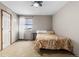 Bedroom showcases neutral carpeting, a ceiling fan, and a window for ample natural light at 6202 Ralston St, Frederick, CO 80530