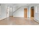 Spacious living room with light hardwood flooring, neutral walls, and stairs to second level at 6202 Ralston St, Frederick, CO 80530
