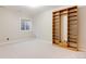 Finished basement room with built-in shelving and large window for natural light at 8757 E Wesley Dr, Denver, CO 80231