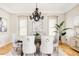 Elegant dining room featuring a chandelier and hardwood floors at 8757 E Wesley Dr, Denver, CO 80231