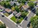 Aerial view of a home showcasing a well-manicured lawn, detached garage, and surrounding neighborhood at 7790 Kendall St, Arvada, CO 80003