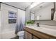 Stylish bathroom featuring modern fixtures, a neutral shower curtain, and tiled walls at 7790 Kendall St, Arvada, CO 80003