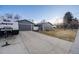 Exterior view of the house with a long driveway, garage, and camper parking at 7790 Kendall St, Arvada, CO 80003