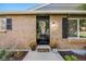 Inviting front entrance with a decorative wreath and blooming potted flowers at 7790 Kendall St, Arvada, CO 80003