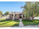 Charming brick home features a well-manicured front lawn and inviting walkway at 7790 Kendall St, Arvada, CO 80003