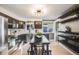 A well-lit kitchen features stainless steel appliances, sleek cabinetry, and a center island with seating at 7790 Kendall St, Arvada, CO 80003