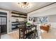 A bright kitchen and dining area offer open space and sleek black accents and seamless view of the living room at 7790 Kendall St, Arvada, CO 80003