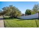 Well-maintained front yard with lush green grass and a white picket fence at 7790 Kendall St, Arvada, CO 80003