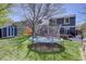 Expansive backyard featuring a trampoline, shed, lush lawn, and exterior view of the home at 8745 W Ottawa Ave, Littleton, CO 80128