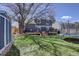 Spacious backyard with a deck, garden area, trampoline, shed, and mature trees providing shade at 8745 W Ottawa Ave, Littleton, CO 80128