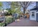Relaxing backyard with a wooden deck, mature trees, and a lush green lawn at 8745 W Ottawa Ave, Littleton, CO 80128