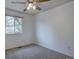 Cozy bedroom with natural light and neutral carpeting at 8745 W Ottawa Ave, Littleton, CO 80128