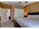 Bedroom features neutral-colored walls, carpet, and a closet with sliding doors at 8745 W Ottawa Ave, Littleton, CO 80128