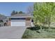 Charming single-story home boasts a brick facade, lush lawn, and a convenient two-car garage at 8745 W Ottawa Ave, Littleton, CO 80128