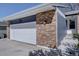 Close-up of the brick and siding on the garage, showing the house number at 8745 W Ottawa Ave, Littleton, CO 80128
