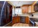 Well-lit kitchen featuring stainless steel appliances, granite countertops, and wood cabinetry at 8745 W Ottawa Ave, Littleton, CO 80128