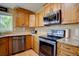 This remodeled kitchen has stainless steel appliances, granite counters, and wood cabinets at 8745 W Ottawa Ave, Littleton, CO 80128