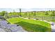 Well-manicured backyard with lush green lawn, stone pathway, and a charming wooden fence at 6912 Sunstrand Ct, Castle Pines, CO 80108
