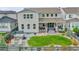 Expansive backyard with a well-manicured lawn, a patio, a hot tub, and comfortable seating at 6912 Sunstrand Ct, Castle Pines, CO 80108
