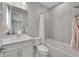 Bathroom features a shower-tub combo with mosaic accent, white vanity, and a toilet at 6912 Sunstrand Ct, Castle Pines, CO 80108