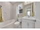 Bright and clean bathroom with shower-tub combo and updated vanity with a marble countertop at 6912 Sunstrand Ct, Castle Pines, CO 80108