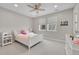 Bright ' bedroom with a ceiling fan, white furniture and carpeted flooring at 6912 Sunstrand Ct, Castle Pines, CO 80108