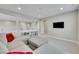 Bright bonus room with plush gray carpet, modern recessed lighting, and comfy gray sectional sofa at 6912 Sunstrand Ct, Castle Pines, CO 80108