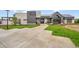 Community clubhouse entrance featuring stone and siding accents with a well-manicured lawn at 6912 Sunstrand Ct, Castle Pines, CO 80108