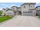 Charming two-story home with a well-manicured lawn, stone accents, and a driveway leading to an attached garage at 6912 Sunstrand Ct, Castle Pines, CO 80108