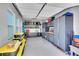 Organized garage featuring ample storage cabinets, shelving, and a clean epoxy floor at 6912 Sunstrand Ct, Castle Pines, CO 80108