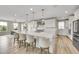 Bright and modern kitchen with a large center island, white cabinets, and stainless steel appliances, perfect for cooking and entertaining at 6912 Sunstrand Ct, Castle Pines, CO 80108