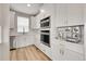 Bright kitchen features stainless appliances, custom cabinets with gold hardware, and a marble backsplash at 6912 Sunstrand Ct, Castle Pines, CO 80108