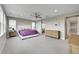 Spacious primary bedroom with large windows, ceiling fan, walk-in closet, and sliding barn door to bathroom at 6912 Sunstrand Ct, Castle Pines, CO 80108