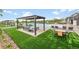 Resort-style pool area with cabanas, lounge chairs, and manicured landscaping at 6912 Sunstrand Ct, Castle Pines, CO 80108