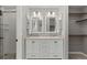 Stylish bathroom with double vanity, elegant mirrors, walk-in shower and walk-in closet at 6393 Laguna Cir, Highlands Ranch, CO 80130